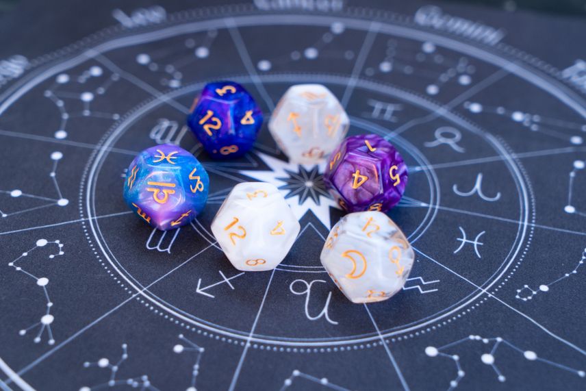 numerology and zodiac dice on an astrology mat