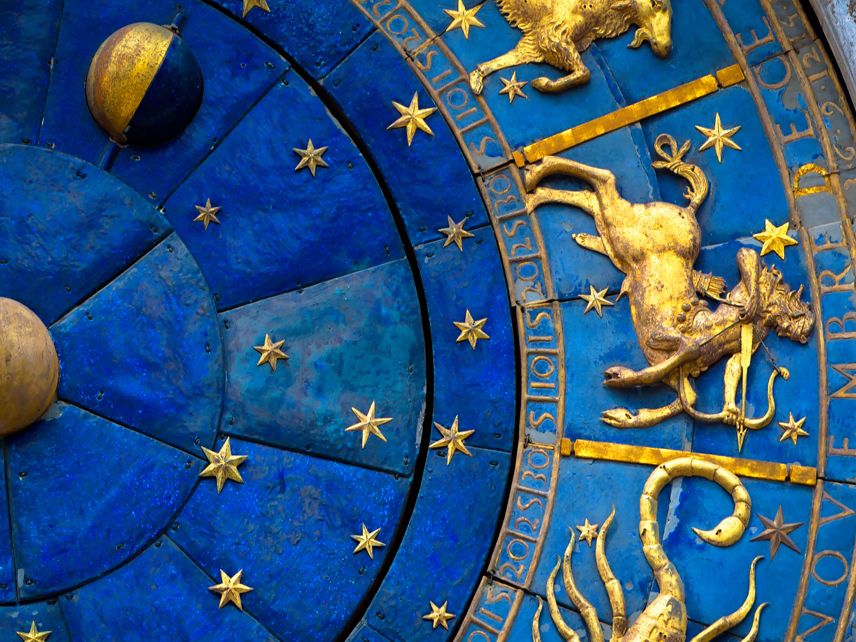 sagitarrius symbol on a blue and gold zodiac wheel Clock