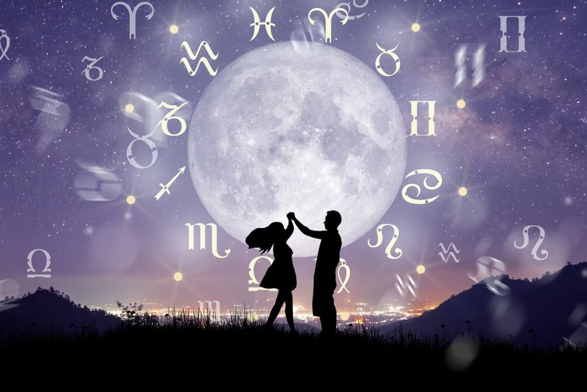 Astrological zodiac signs inside of horoscope circle. Couple singing and dancing over the zodiac wheel and milky way background. The power of the universe concept.